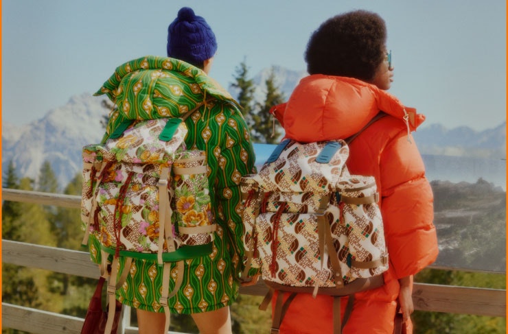 Two people with The North Face x Gucci backpacks on.